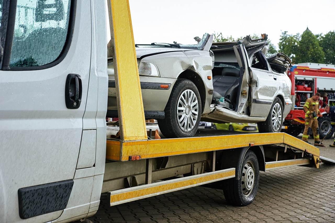 Pontiac Towing - Crashed car loading into tow truck after traffic accident on road